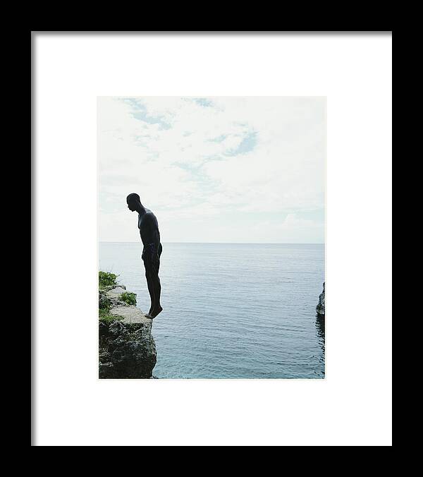 Diving Into Water Framed Print featuring the photograph Jamaica, Negril, Man Standing On Edge by Momo Productions