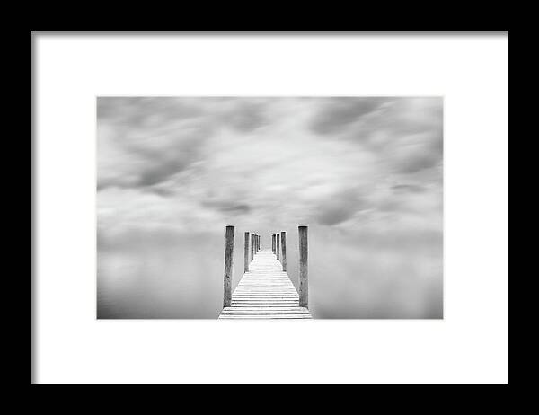 Tranquility Framed Print featuring the photograph Jetty Against Cloudy Sky by Doug Chinnery