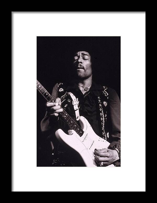 Rock Music Framed Print featuring the photograph Jimi Hendrix Performs by Hulton Archive
