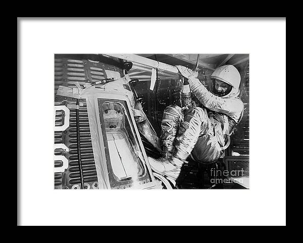 Headwear Framed Print featuring the photograph John Glenn Climbing Into Space Capsule by Bettmann