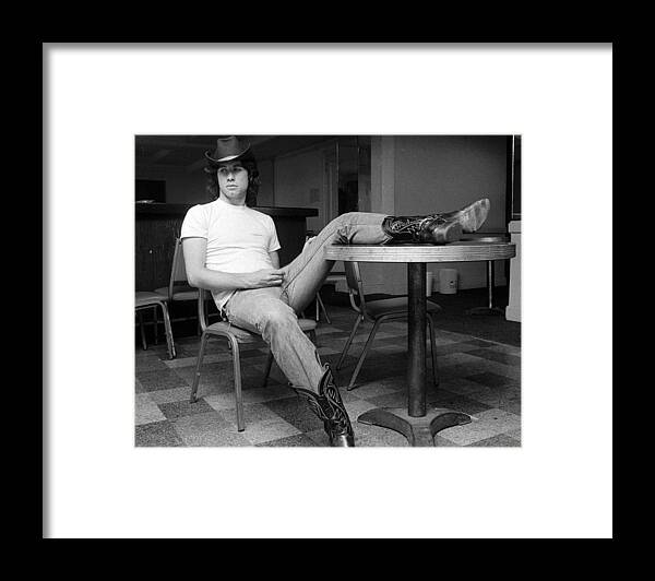 John Travolta Framed Print featuring the photograph John Travolta, With His Hat And Boots by New York Daily News Archive