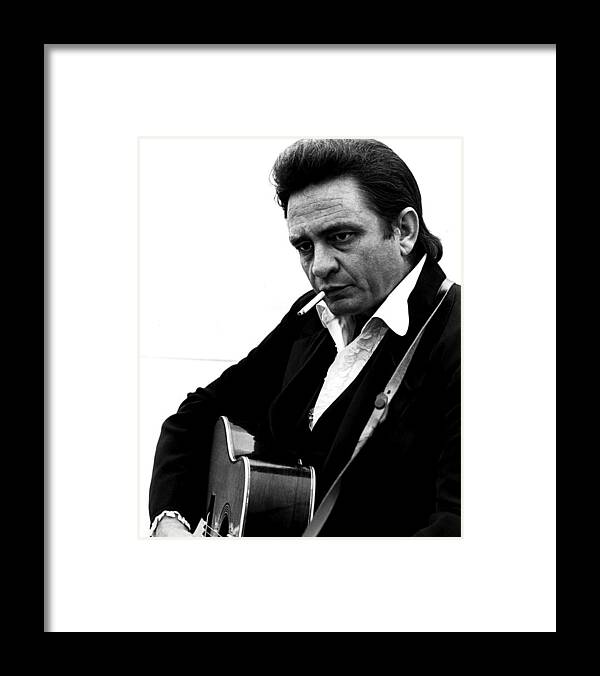 #johnny_cash Framed Print featuring the photograph Johnny Cash Playing Guitar And Smoking At Folsom Prison by Globe Photos