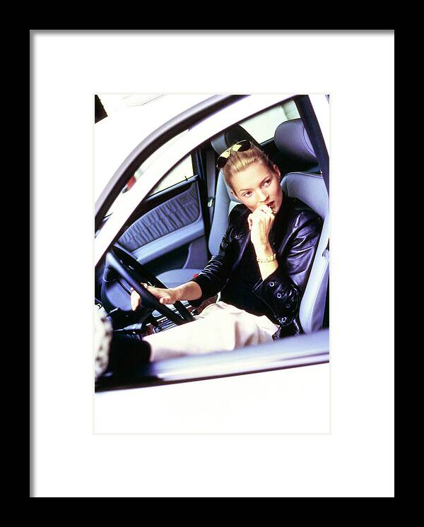Auto Framed Print featuring the photograph Kate Moss Sits At The Wheel Of A Car by Arthur Elgort