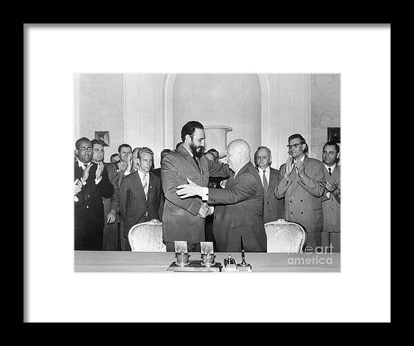 People Framed Print featuring the photograph Khrushchev And Castro Shaking Hands by Bettmann