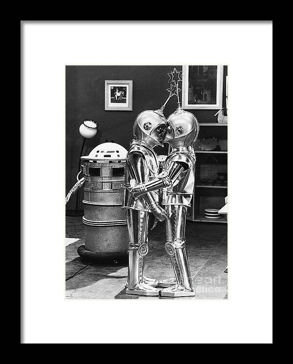 People Framed Print featuring the photograph Kissing Robots by Bettmann