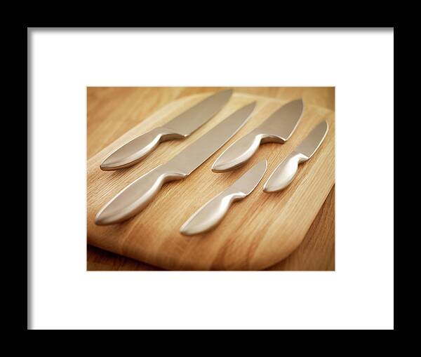 Surbiton Framed Print featuring the photograph Kitchen Knives On A Wooden Chopping by Adam Gault