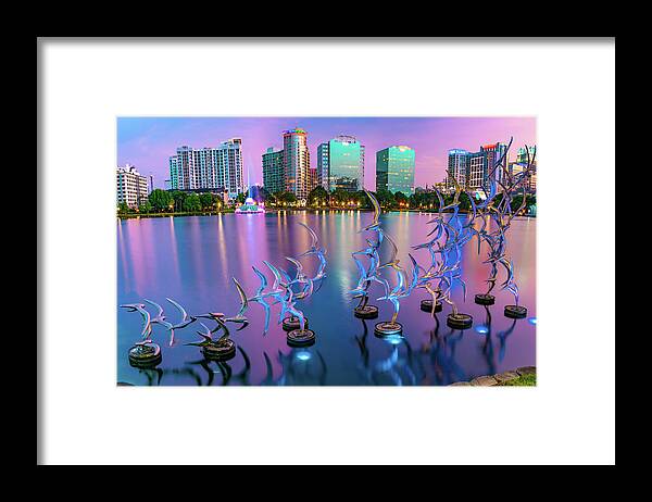 America Framed Print featuring the photograph Lake Eola Take Flight and Orlando Skyline at Dusk by Gregory Ballos