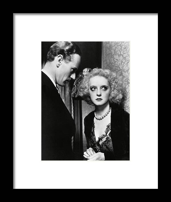 Bette Davis Framed Print featuring the photograph LESLIE HOWARD and BETTE DAVIS in OF HUMAN BONDAGE -1934-. by Album