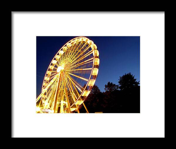 Curve Framed Print featuring the photograph Lighted Ferris Wheel Spinning In Motion by Vfka