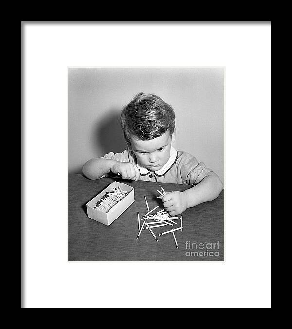 Toddler Framed Print featuring the photograph Little Boy Playing With Matches by Bettmann