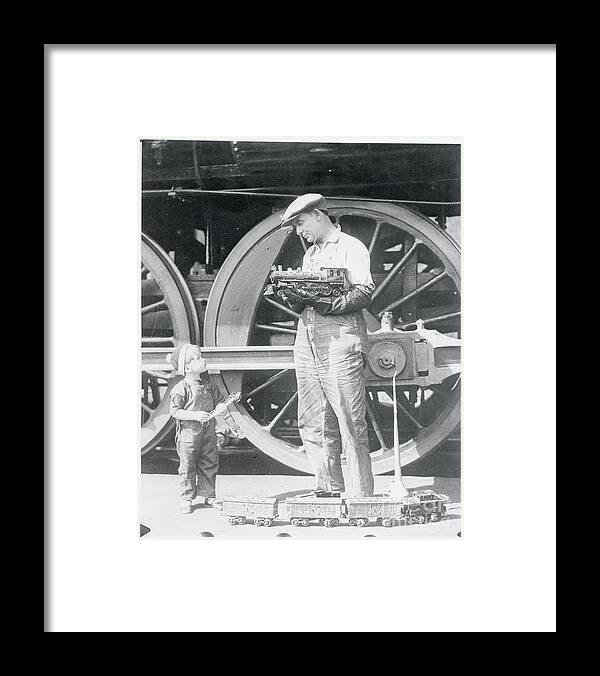 Expertise Framed Print featuring the photograph Locomotive Engineer Holding Model Train by Bettmann