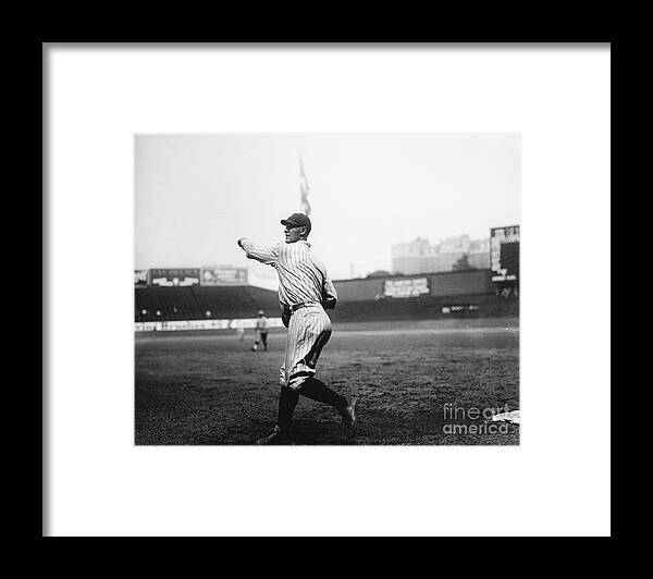 People Framed Print featuring the photograph Lou Gehrig Throwing Baseball by Bettmann