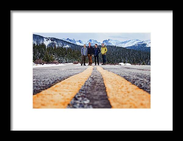 Friends Framed Print featuring the photograph Low Angle View Of Friends Standing On Street Against Snowcapped Mountains by Cavan Images