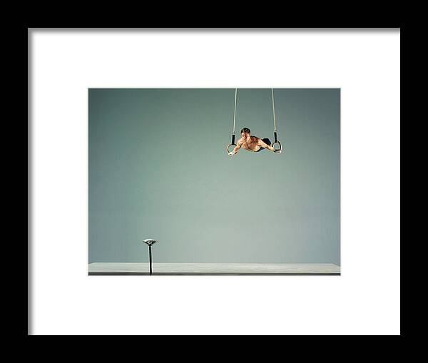 Hanging Framed Print featuring the photograph Male Athlete Practising A Rings Exercise by 10'000 Hours
