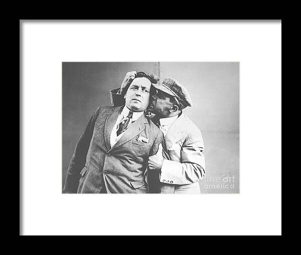 People Framed Print featuring the photograph Man Biting Rival On The Ear by Bettmann