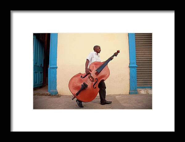 Mature Adult Framed Print featuring the photograph Man Carrying Bass To Gig by Grant Faint