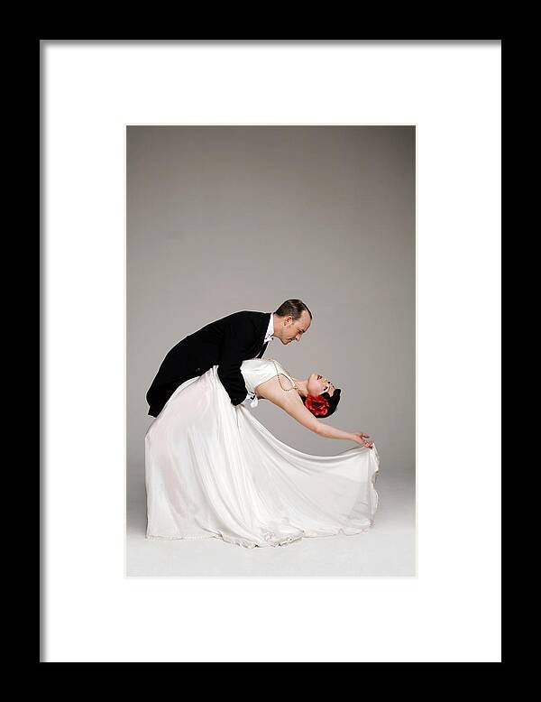 Heterosexual Couple Framed Print featuring the photograph Man In Tuxedo Dipping Woman In White by Allison Michael Orenstein