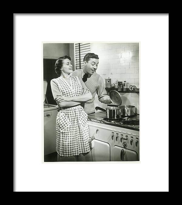 Heterosexual Couple Framed Print featuring the photograph Man Looking Into Pot In Domestic by George Marks