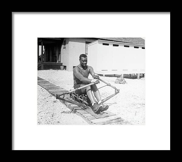 People Framed Print featuring the photograph Man Practicing Rowing On A Machine by Bettmann