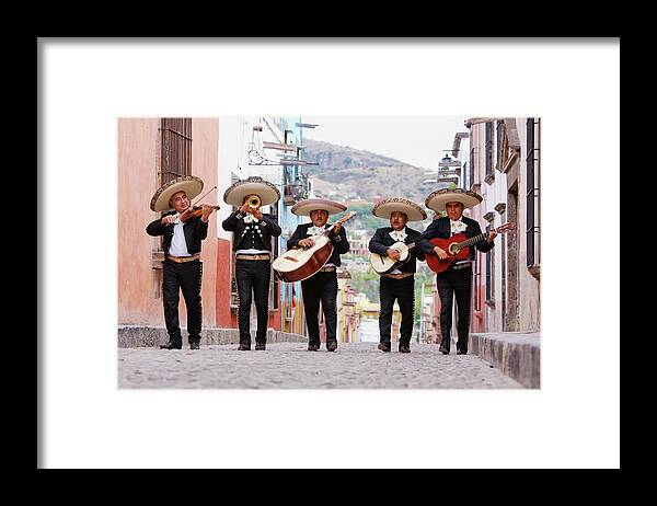 Mature Adult Framed Print featuring the photograph Mariachi Band Walking In Street by Pixelchrome Inc