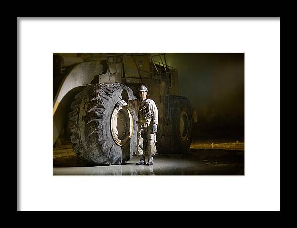 Expertise Framed Print featuring the photograph Mining Worker Standing Beside Tyre In by Tyler Stableford