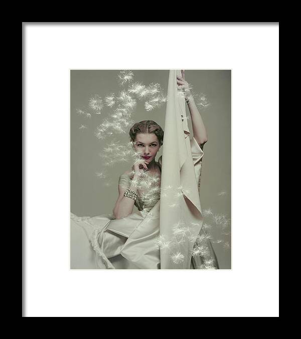 #new2022vogue Framed Print featuring the photograph Model With Silk And Floating Dandelion Seeds by Herbert Matter