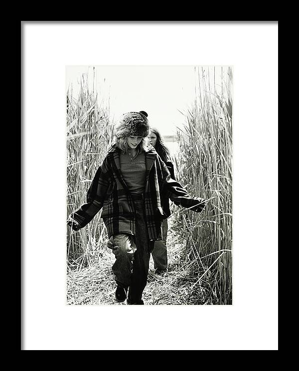 #new2022vogue Framed Print featuring the photograph Models Walking Through A Wheat Field by Arthur Elgort