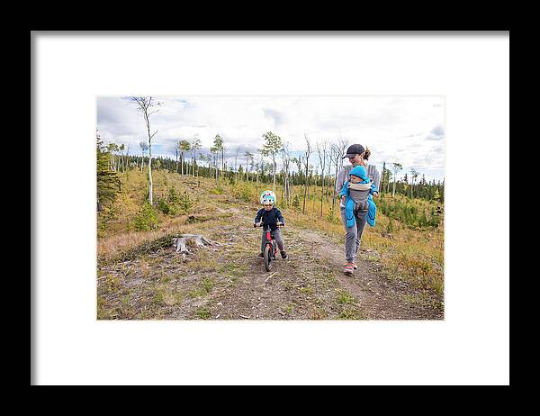 Copy Space Framed Print featuring the photograph Mother On Walk With Baby And Toddler On Bike. by Cavan Images