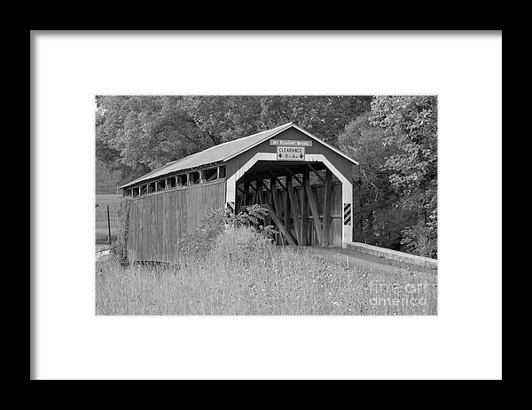 Mt Pleasant Covered Bridge Framed Print featuring the photograph Mt. Pleasant Covere Bridge Through The Grass Black And White by Adam Jewell