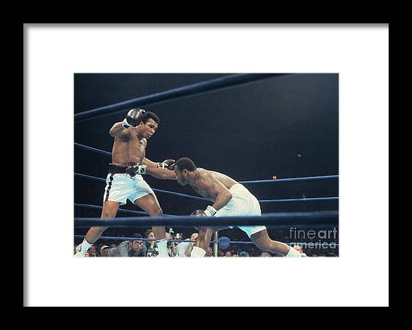 Joe Frazier Framed Print featuring the photograph Muhammad Ali Boxing Against Joe Frasier by Bettmann
