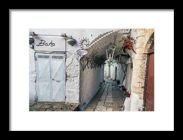 Ostuni Framed Print featuring the photograph Narrow alley in Ostuni by Claudio Maioli