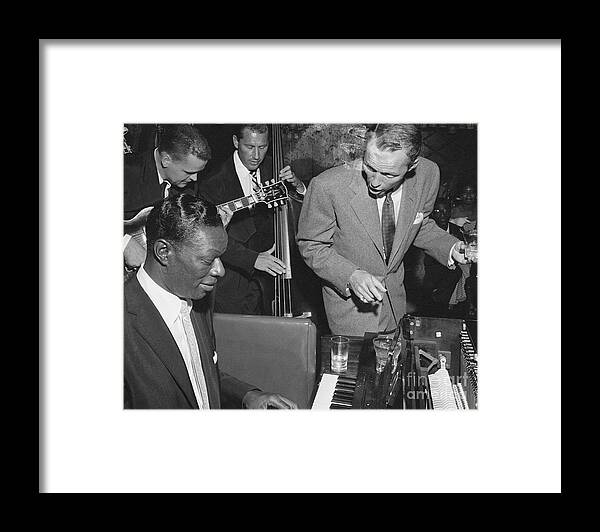 Singer Framed Print featuring the photograph Nat King Cole Playing With Frank Sinatra by Bettmann
