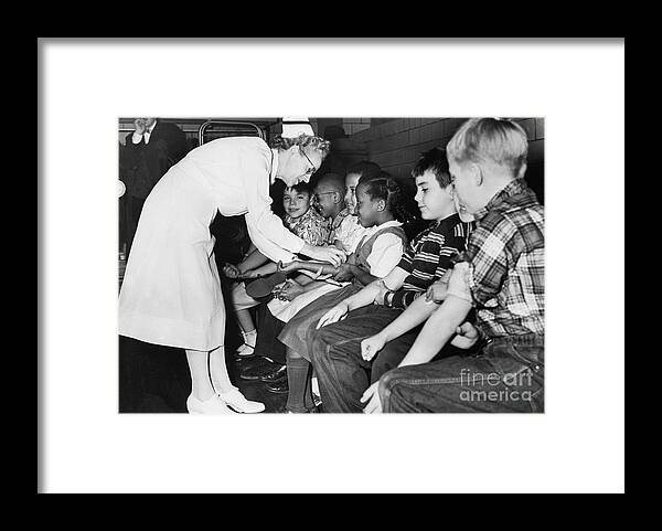 Event Framed Print featuring the photograph Nurse Preparing Children For Polio by Bettmann
