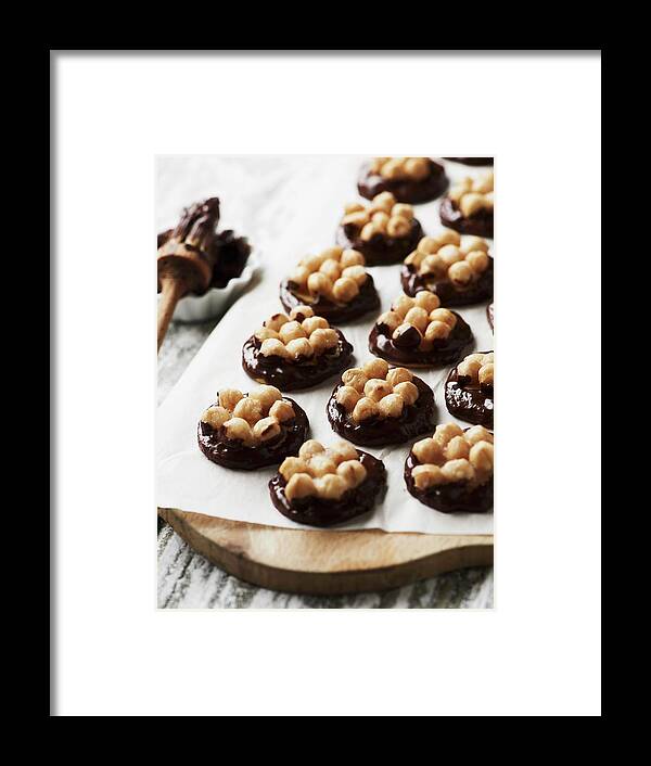 Ip_11273072 Framed Print featuring the photograph Nut Biscuits With Dark Chocolate On A Piece Of Paper by Hannah Kompanik