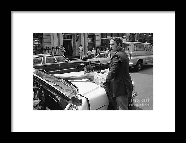 New York City Police Department Framed Print featuring the photograph Nypd Officer Arresting Suspect by Bettmann