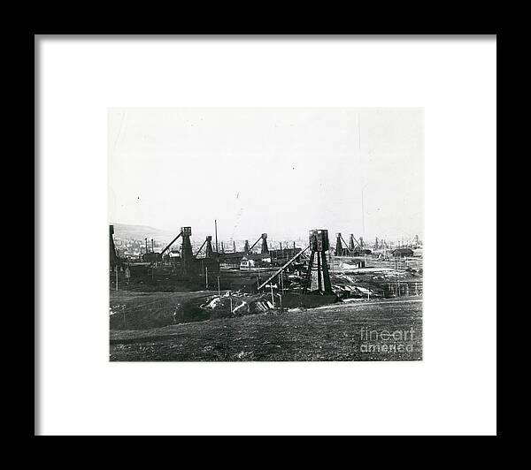 Finance And Economy Framed Print featuring the photograph Oil Field With Old Wooden Structures by Bettmann