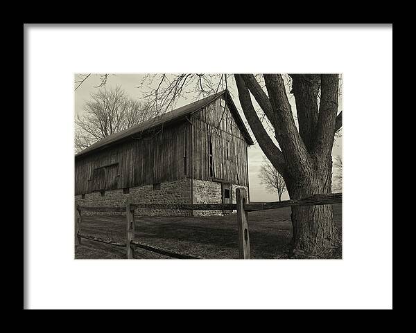 Old Weathered Barn And Wooden Fence B&w Framed Print featuring the photograph Old Weathered Barn And Wooden Fence B&w by Anthony Paladino