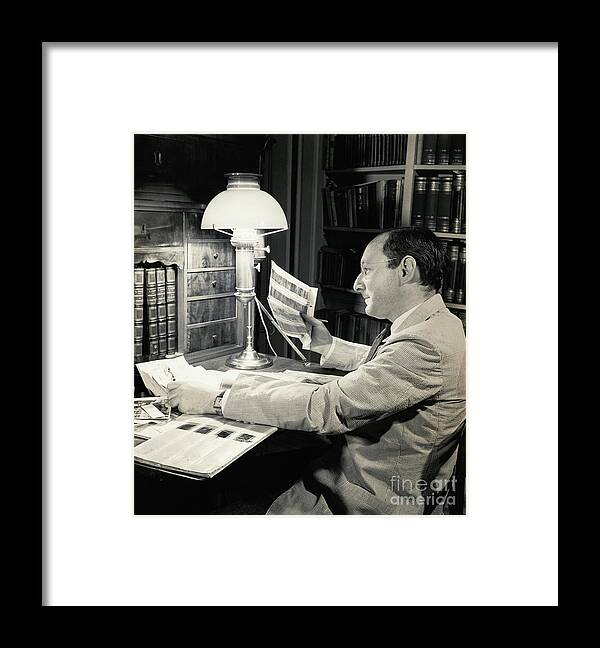 Working Framed Print featuring the photograph Otto Bettmann Examining Negatives by Bettmann