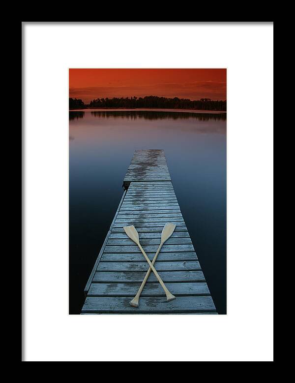 Scenics Framed Print featuring the photograph Paddles On Lake Dock At Dusk by Imaginegolf