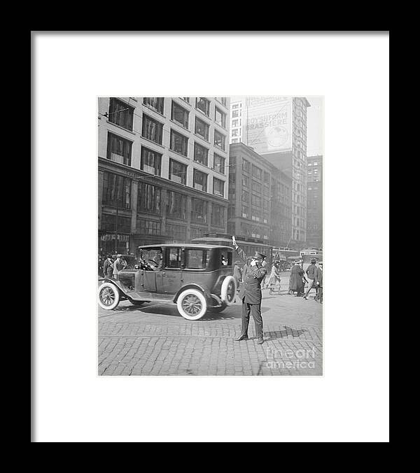 People Framed Print featuring the photograph Police Officer Directing Traffic by Bettmann