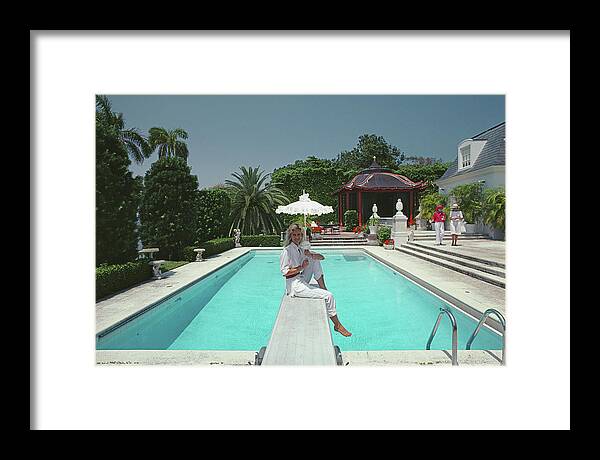 1980-1989 Framed Print featuring the photograph Pool And Parasol by Slim Aarons