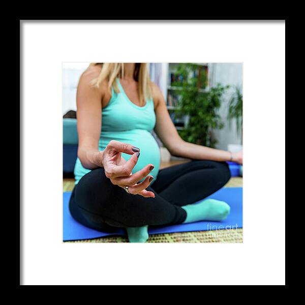 Pregnancy Framed Print featuring the photograph Pregnant Woman Doing Yoga At Home by Microgen Images/science Photo Library
