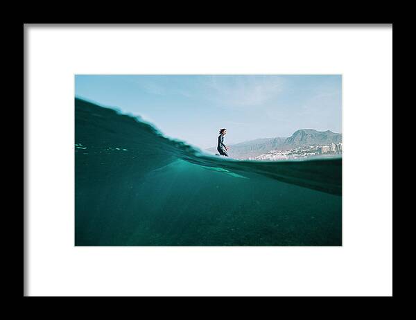 Lifestyles Framed Print featuring the photograph Pulled Back Split Image Of Female Surfer In Wetsuit On A Wave by Cavan Images