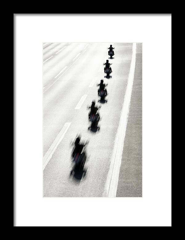 In A Row Framed Print featuring the photograph Rear View Of Row Of Motorcycle Riders by Jorg Greuel
