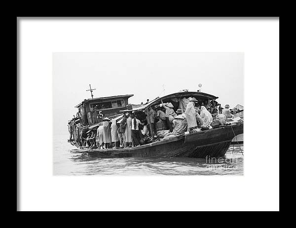 Mid Adult Women Framed Print featuring the photograph Refugees Huddled On Boat In Rain Downpou by Bettmann