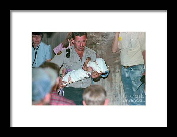 1980-1989 Framed Print featuring the photograph Rescuer Running With Baby Jessica by Bettmann