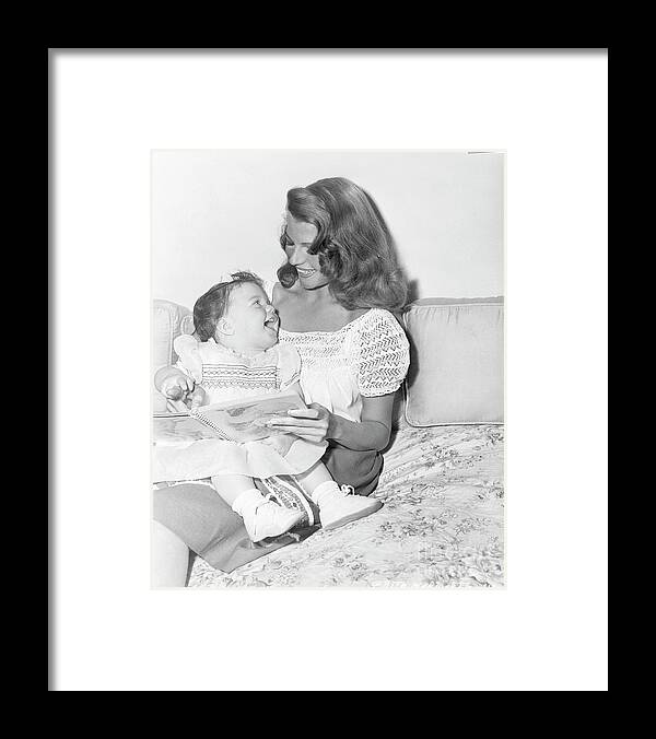 Mid Adult Women Framed Print featuring the photograph Rita Hayworth Reading To Daughter by Bettmann
