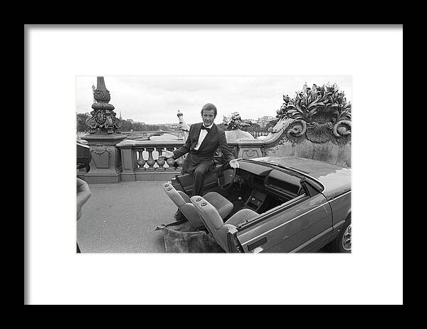 1980-1989 Framed Print featuring the photograph Roger Moore In Paris by Larry Ellis