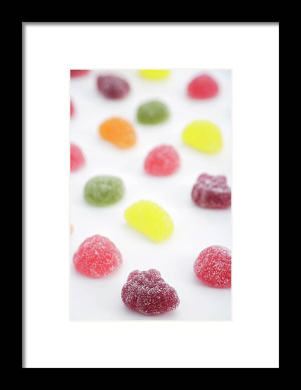 Unhealthy Eating Framed Print featuring the photograph Rows Of Sugared Gum Drops On Paper by Asia Images
