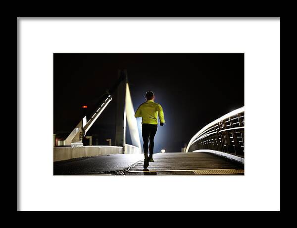 Asian And Indian Ethnicities Framed Print featuring the photograph Runner On Bridge by Henrik Sorensen